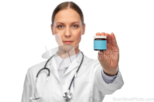 Image of female doctor holding jar of medicine
