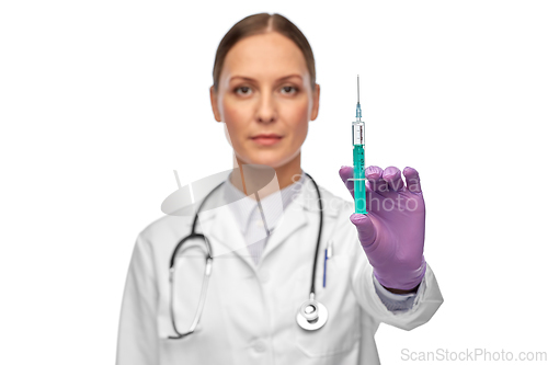 Image of female doctor with medicine in syringe