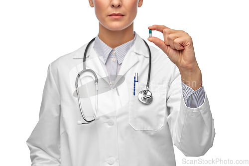 Image of close up of female doctor holding medicine pill