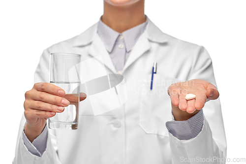 Image of female doctor with medicine and glass of water