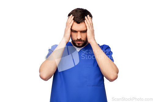 Image of stressed doctor or male nurse in blue uniform