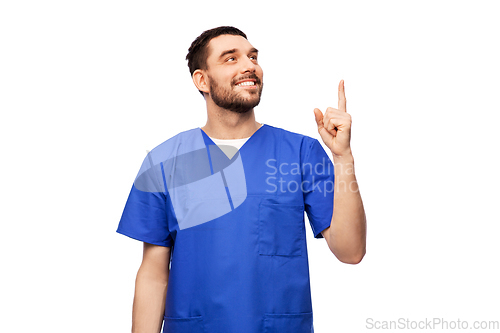 Image of smiling doctor or male nurse pointing finger up