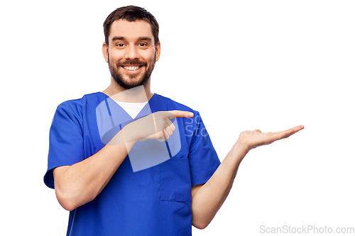 Image of smiling male doctor holding something on hand