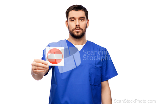 Image of doctor or male nurse showing stop sign