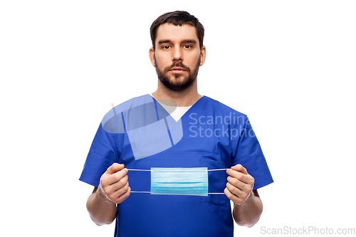 Image of male doctor in blue uniform with mask