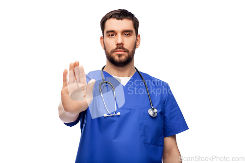 Image of doctor or male nurse showing stop gesture