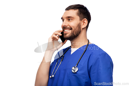 Image of smiling doctor or male nurse calling on smartphone