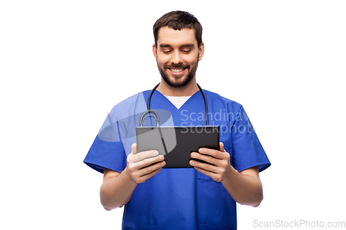 Image of smiling doctor or male nurse using tablet computer