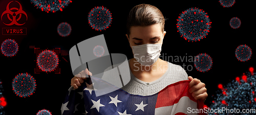 Image of sick woman in face mask holding flag of america