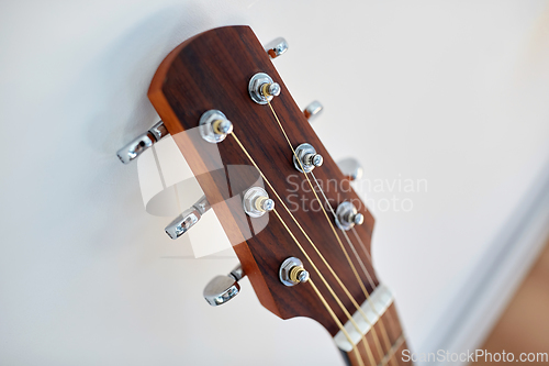 Image of close up of acoustic guitar head with pegs