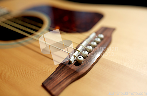 Image of close up of acoustic guitar strings