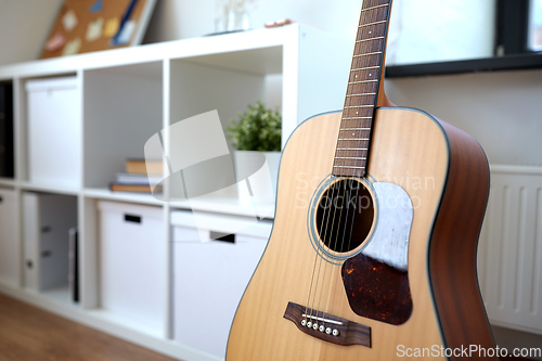 Image of close up of acoustic guitar at home