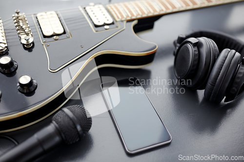 Image of close up of bass guitar and smartphone