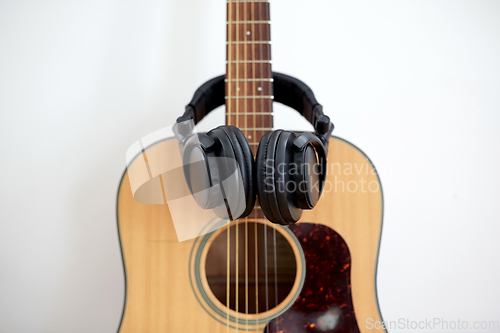 Image of close up of acoustic guitar and headphones