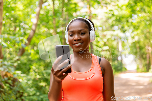 Image of african american woman with headphones and phone