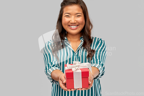 Image of happy asian woman with birthday present