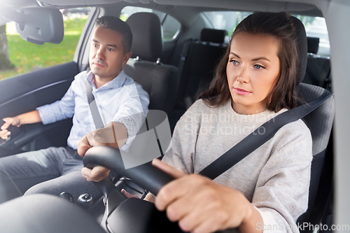 Image of car driving school instructor teaching woman