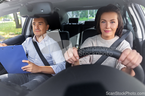 Image of car driving school instructor and young driver