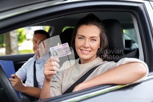 Image of car driving instructor and driver with license