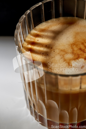 Image of close up of coffee in glass on table