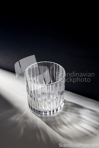 Image of empty faceted glass on table