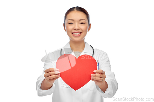 Image of smiling asian female doctor holding red heart