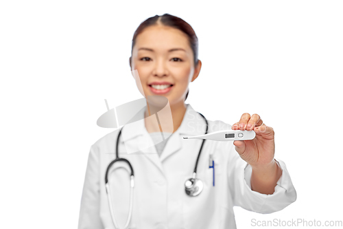 Image of smiling asian female doctor with thermometer