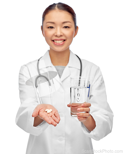 Image of asian doctor with medicine and glass of water