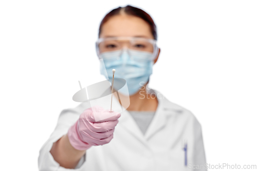 Image of asian female doctor in mask with test cotton swab