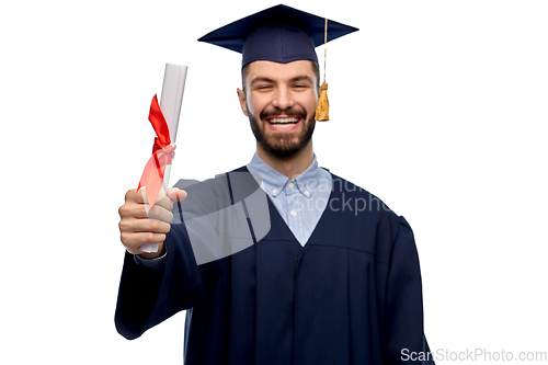 Image of male graduate student in mortar board with diploma