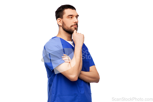 Image of thinking doctor or male nurse in blue uniform