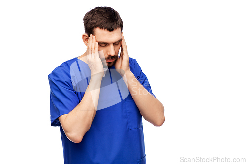 Image of stressed doctor or male nurse in blue uniform