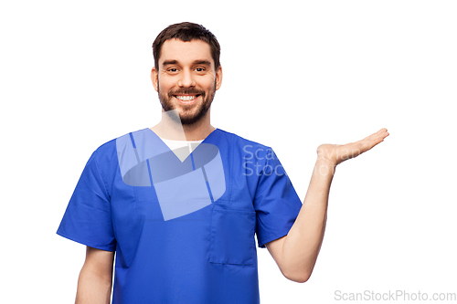 Image of smiling male doctor holding something on hand