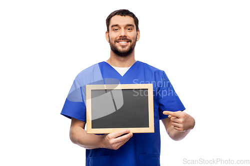 Image of happy smiling male doctor or nurse with chalkboard