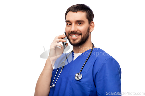 Image of smiling doctor or male nurse calling on smartphone