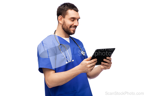 Image of smiling doctor or male nurse using tablet computer