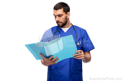 Image of male doctor reading medical report in folder