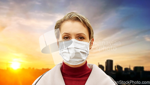 Image of young woman wearing protective medical mask