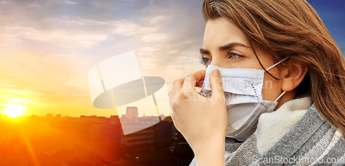 Image of young woman wearing protective medical mask