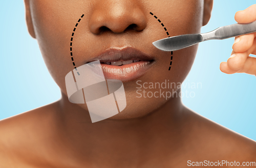 Image of face of african american woman and scalpel knife