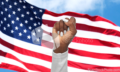 Image of hand of african woman over american flag