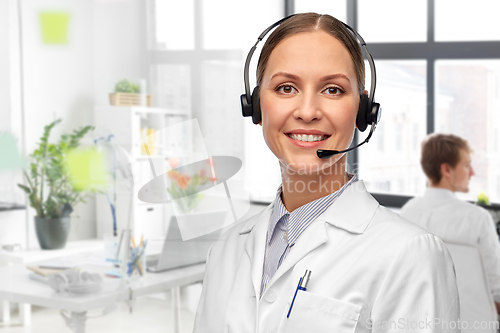 Image of smiling female doctor with headset at hospital