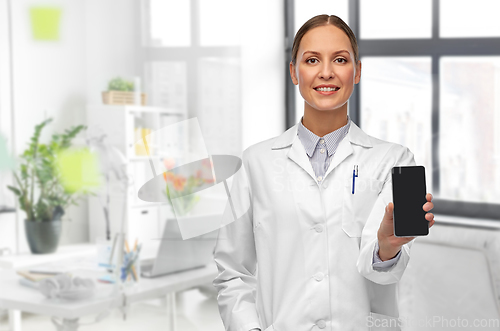 Image of smiling female doctor with smartphone at hospital