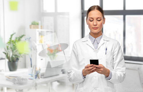 Image of female doctor with smartphone at hospital