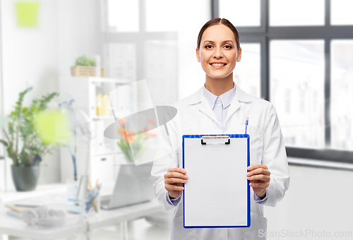 Image of smiling female doctor with clipboard at hospital