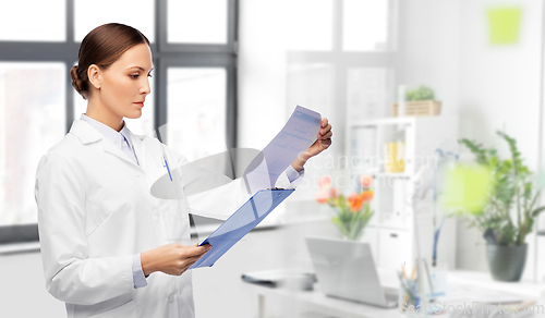 Image of female doctor with medical report at hospital