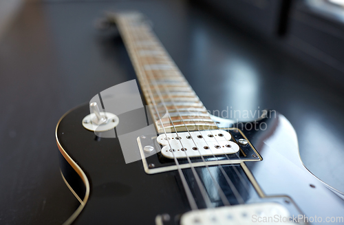 Image of close up of bass guitar strings on windowsill