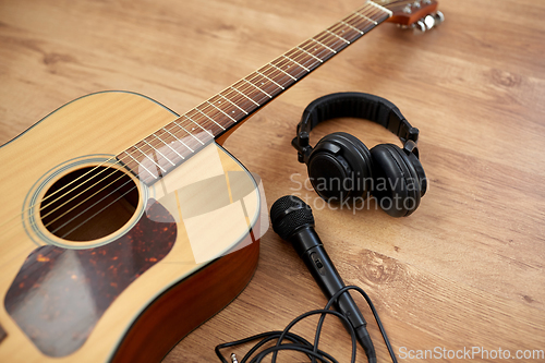 Image of close up of guitar, microphone and headphones