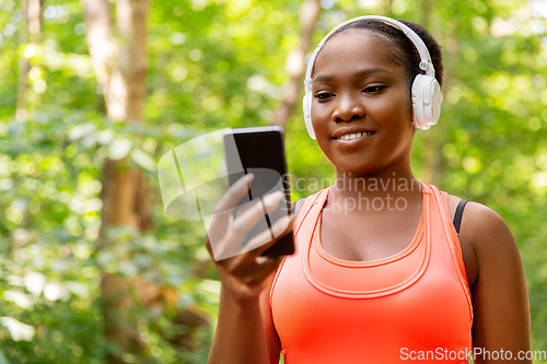 Image of african american woman with headphones and phone