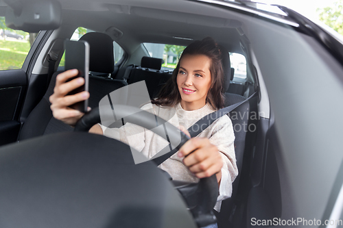 Image of woman or driver driving car and taking selfie